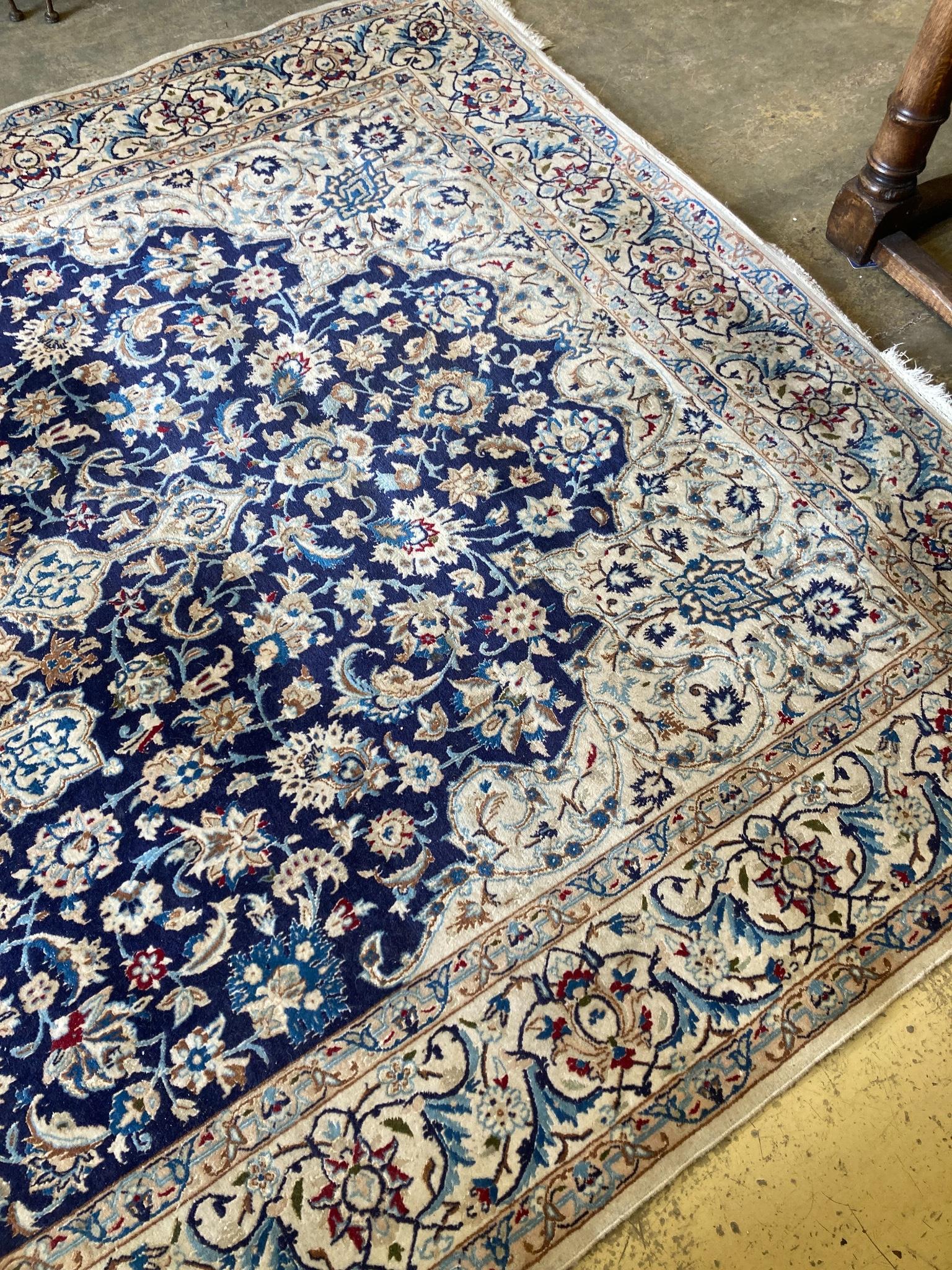 A North West Persian ivory ground carpet, 325 x 203cm